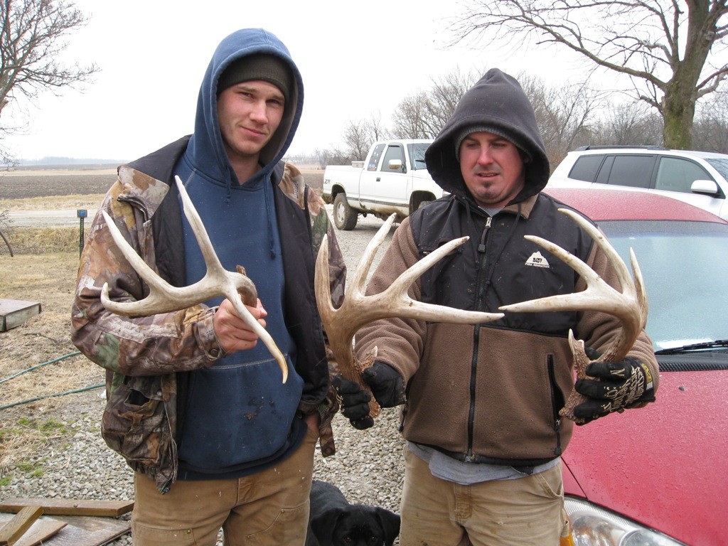 Pictures of men holding shed deer antlers.
